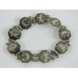 A niello sterling silver articulated bracelet having nine octagonal panels each featuring