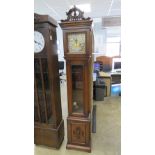 A contemporary long case clock having square shaped dial with Roman numerals upon twelve enamelled