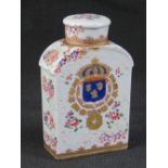 A ceramic lidded flask decorated with floral enamel throughout and bearing heraldic motif to one