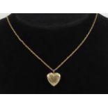 A 14ct gold locket in the form of a heart, having floral engraving to front, stamped 14k, 1.