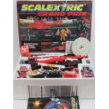 A Scalextric Grand Prix set in box having two race cars, track, penalty cars, barriers,