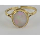 A 9ct gold opal ring having green/red fire, opal measuring 9 x 6.