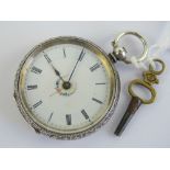 A silver key wind fob watch having white enamel dial with floral wreath to centre,