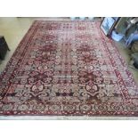 A woollen and silk rug in reds and browns having geometric decoration upon 300 x 220cm.