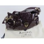 Aspinal of London; a purple patent leather handbag, 36cm wide,