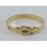 A finely made hinged bangle in the form of belt and buckle,