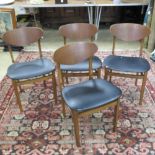 A set of four mid 20th century chairs in the style of G-Plan, having navy leatherette seats.