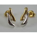 A pair of diamond 18ct white and yellow gold stud earrings, each hallmarked 750, 1.9g.
