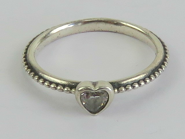A silver Pandora ring having heart set with white stone to centre, marked S925 ALE 54,