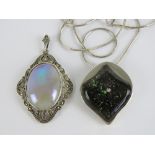 A silver and marcasite pendant with central lustre glaze cabachon, 5cm in length inc bale.