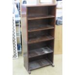 A five shelf oak and mahogany open-fronted bookcase 124 x 58 x 26cm.