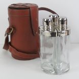 A set of three flasks within fitted leather travelling case, complete with carry strap.