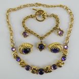 Trifari; a vintage costume necklace set with purple cabachons and having leaf shaped panels,
