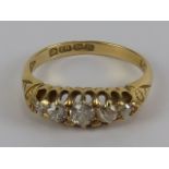 An 18ct gold and diamond 5 stone carved head ring, approx 0.