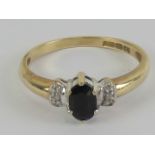 A 9ct gold sapphire and diamond ring, central oval cut sapphire approx 0.