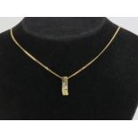 A 9ct gold pendant in the form of two bars, each set with square cut cz stone,