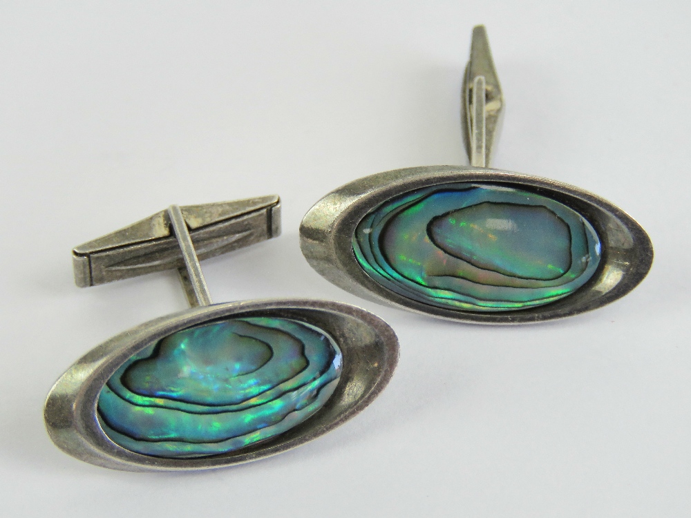 A pair of sterling silver and abalone shell cuff links stamped STG925, 3cm wide.