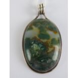 A large chalcedony and green agate pendant having white metal frame, no apparent hallmarks, 6.