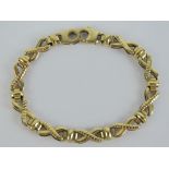 A 9ct gold articulated X-link and bar pattern bracelet, hallmarked 375,