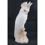 A 19th century carved alabaster cockateal a/f to crest, with glass eyes, 33cm high.