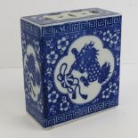 An Oriental blue and white ceramic incense stand decorated with fo dogs upon, standing 14.5cm high.