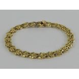 A 14ct gold articulated bracelet each panel in the form of a leaf, stamped 14k, 18.