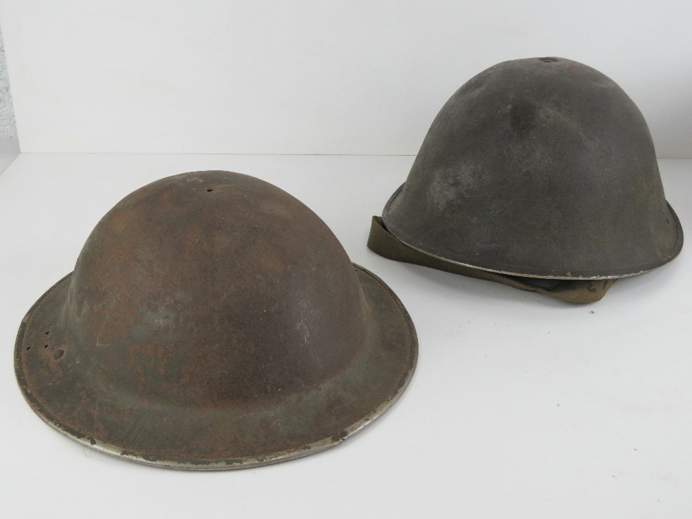 Two WWII British Army helmets.