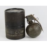 An inert US Military Vietnam Wra M67 'Baseball' grenade dated 1973, in stores pot.