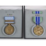 Two US military medals in boxes; Korea (bar deficient), and another for military achievement.
