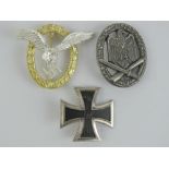Three reproduction WWII German badges; Iron Cross 1st Class, Ground Assault, and Paratrooper.