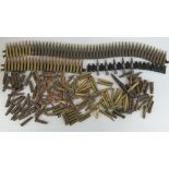 A large quantity of assorted inert bullets some on a machine gun belt.