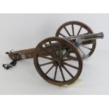 A deactivated table top 12 bore muzzle loading cannon and gun carriage, overall length approx 70cm,