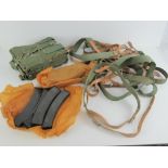 A quantity of PPS-43 slings, mag pouches and magazines.