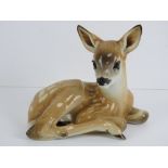 A rare SS Allach porcelain figure of a curled up fawn in light brown ground decorated with white