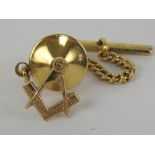 Masonic; a 9ct gold tie pin in the form of square and compass, 12mm high and stamped 9ct gold,