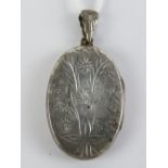 A HM silver locket having floral engravi