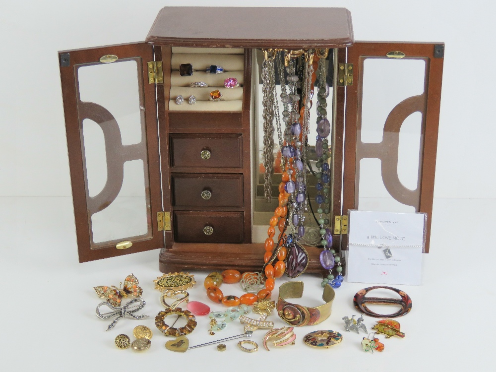 A two-door jewellery cabinet containing