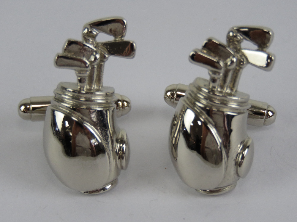 A pair of cuff links in the form of golf