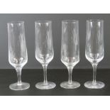 A set of four Orrefors Swedish Crystal champagne flutes each standing 19.5cm high.