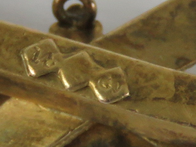 A gold and sapphire brooch having arrow and flower design, indistinct marks to back, 4.2cm wide. 2. - Image 2 of 2