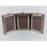 Asprey; A HM silver folding photograph frame to hold three photos, each measuring 14 x 9cm,