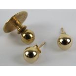 A pair of 9ct gold stud earrings, stamped 375, together with a 9ct gold shirt stud. Total weight 1.