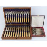 A set of twelve fish knives and forks all within a fitted wooden canteen.