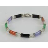 A jade and onyx panelled bracelet having white metal fittings (partial mark indistinct),
