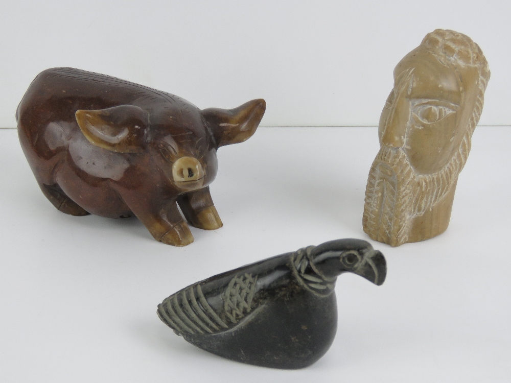 A carved stone pig figurine, 14cm in length, together with two other carved stone figurines.