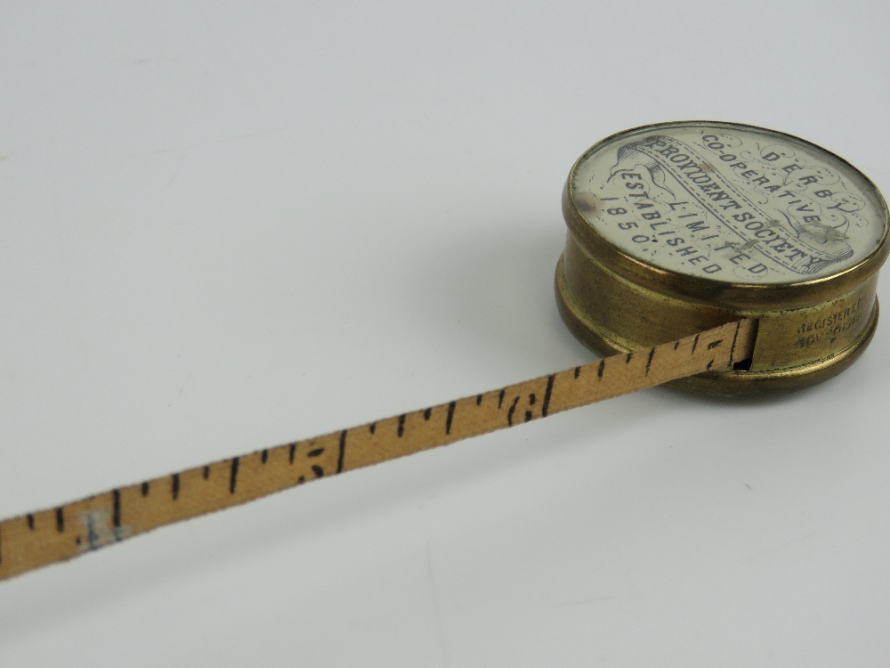 A Derby Cooperative Providence Society miniature brass 36" cloth retracting tape measure in brass - Image 4 of 4