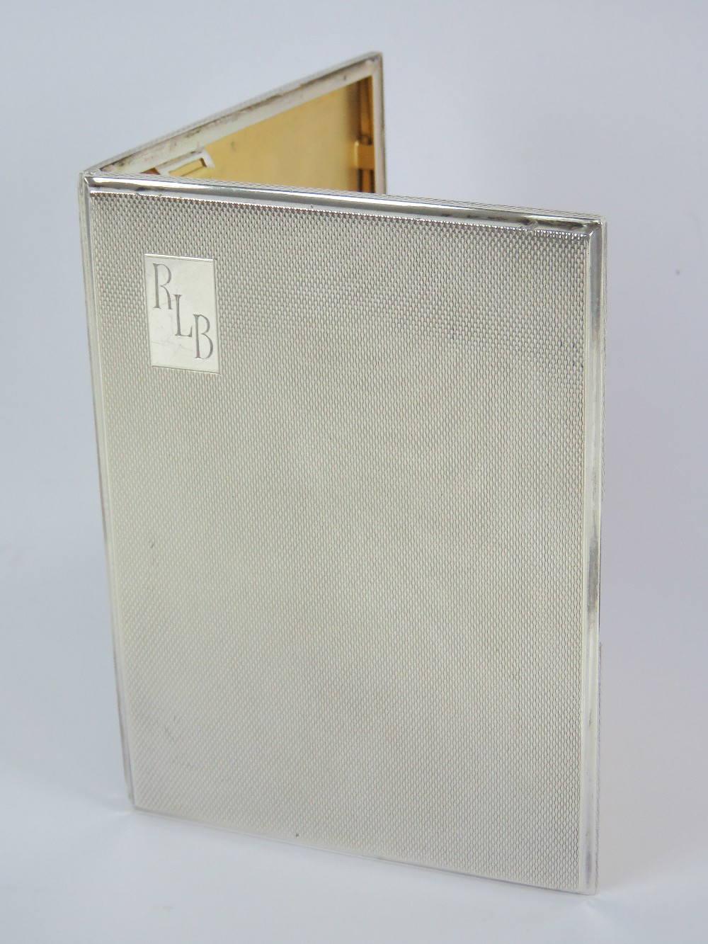 A hallmark silver cigarette case having engine turned engraved pattern throughout, gilt interior,