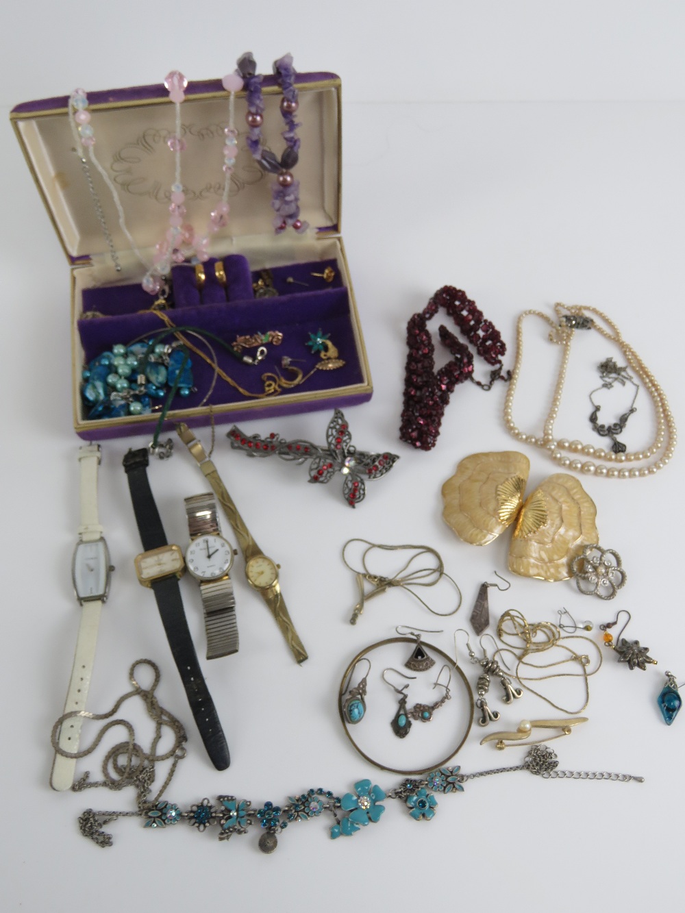 A quantity of assorted jewellery within purple velvet jewellery box includes some single silver