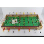 A 1970s Arcofalc Italian made table football game with full complement of players and two balls.