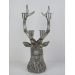 A table decoration in the form of a stags head complete with five point antlers having four candle